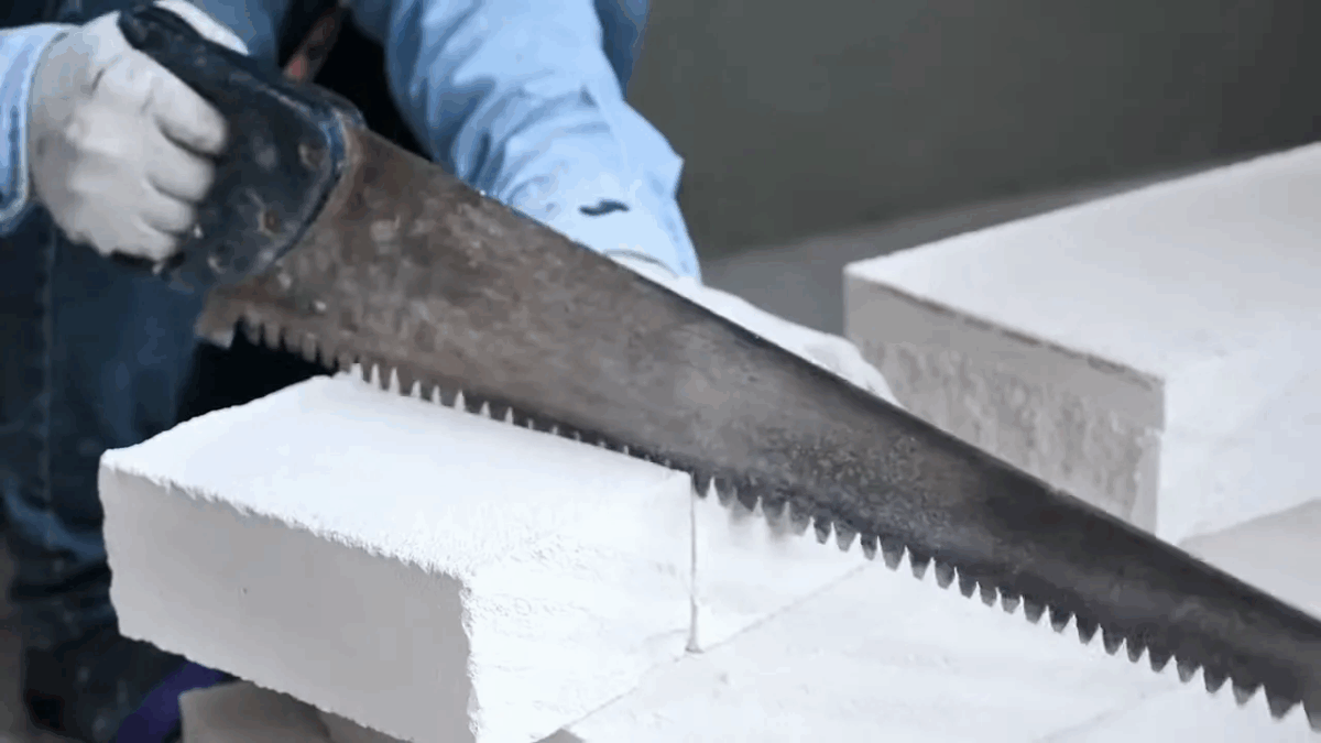 Person applying insulation panels to inside of garage door